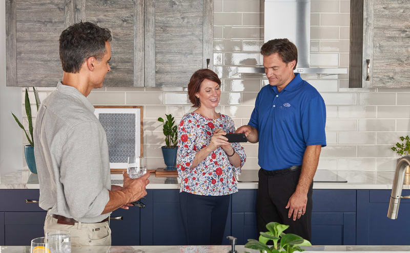 a carrier dealer shows a couple an ac unit calculator