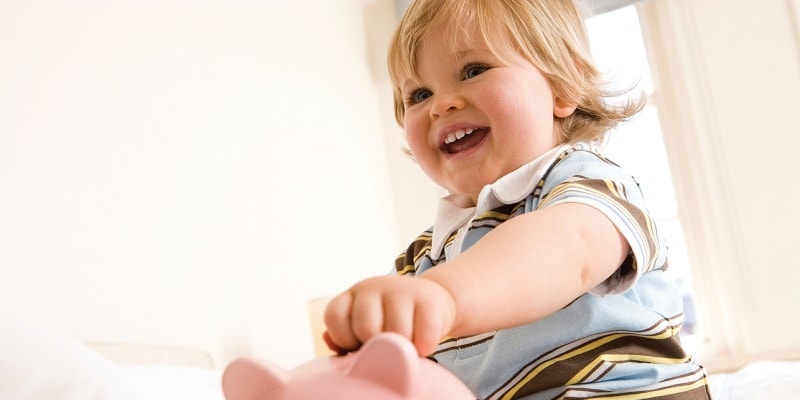 baby-holding-piggy-bank