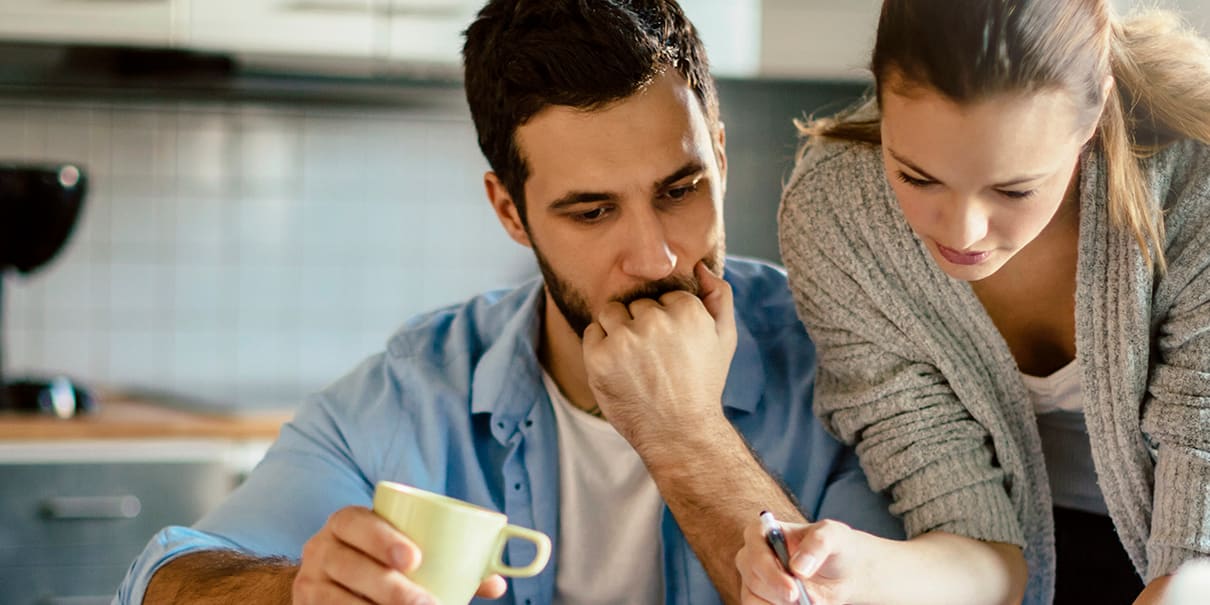 couple-at-kitchen-table-with-coffee-reviewing-finances-3x2