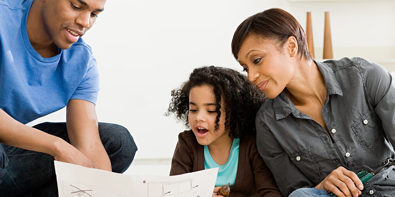 three-person-family-looking-at-house-information-3x2