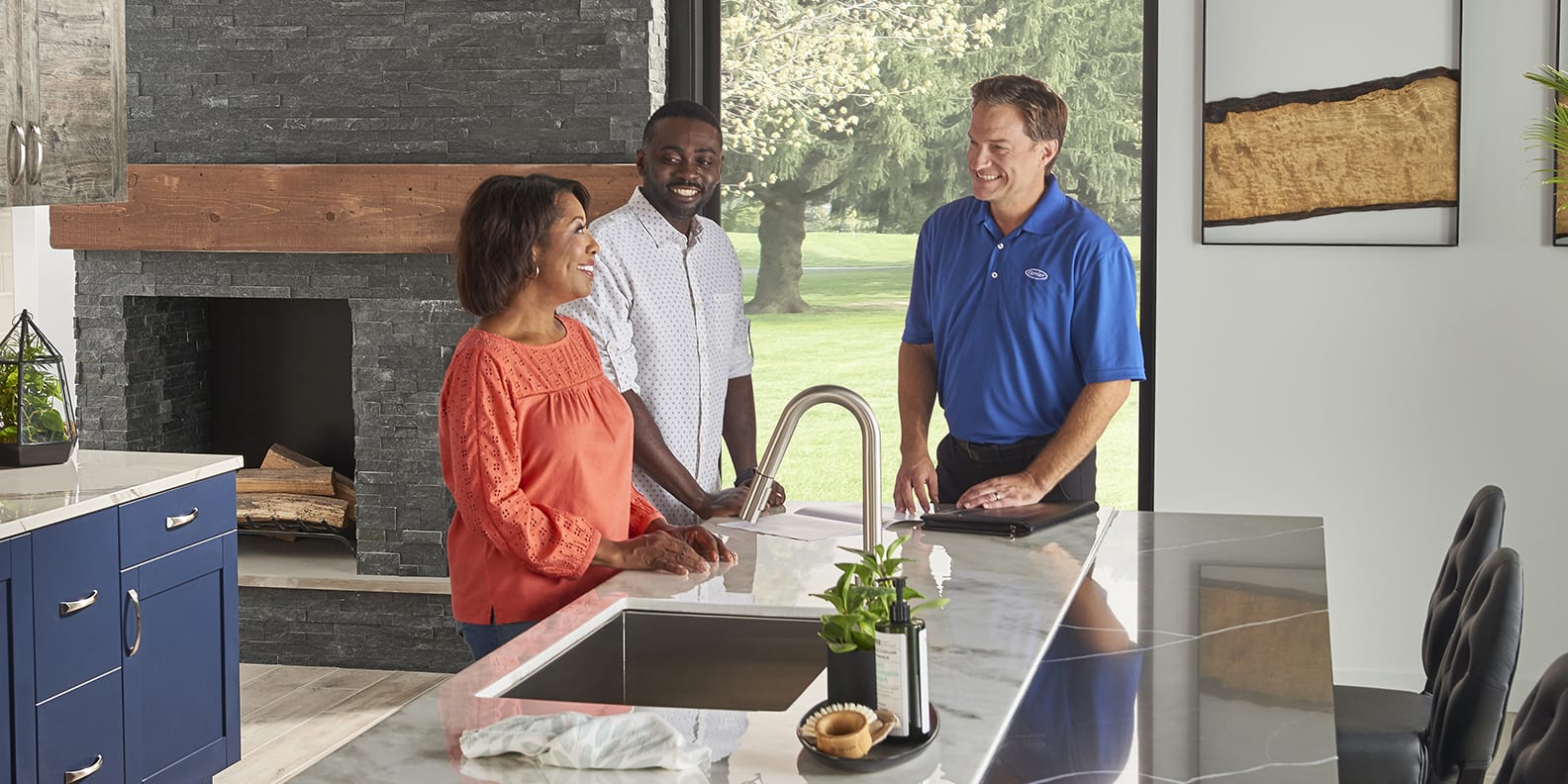 hvac-dealer-discussing-fixing-mini-split-leaking-water-with-couple-in-kitchen