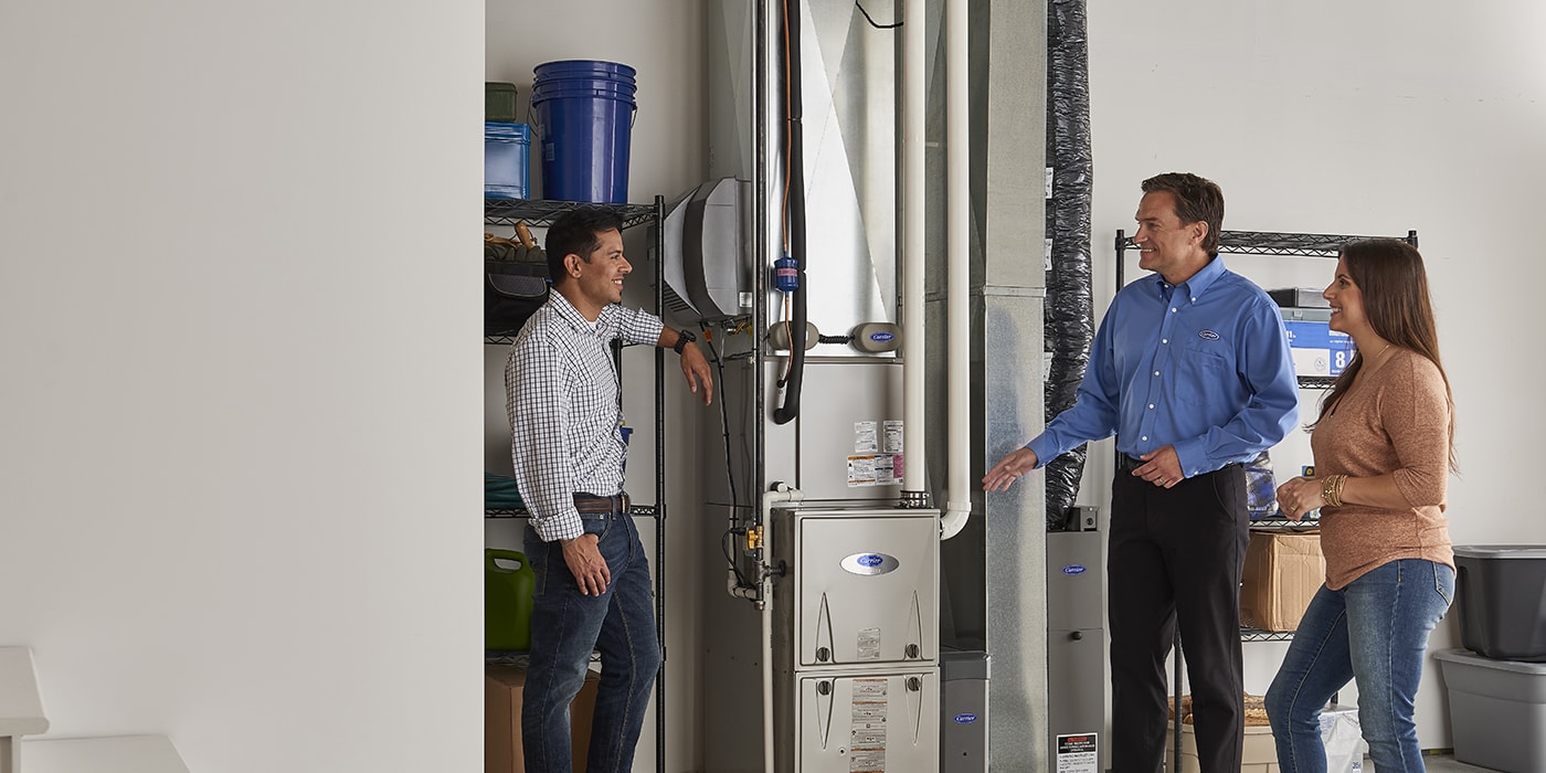 dealer-near-a-furnace-explaining-to-a-couple-what-is-a-merv-rating