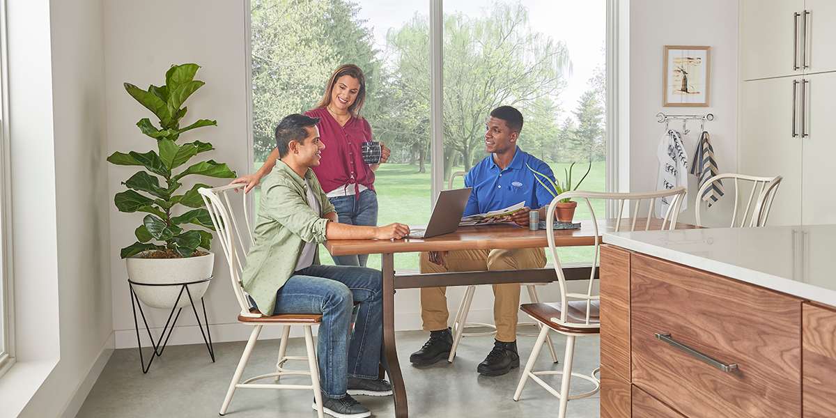 carrier-dealer-discusses-air-conditioning-unit-compressors-with-homeowner