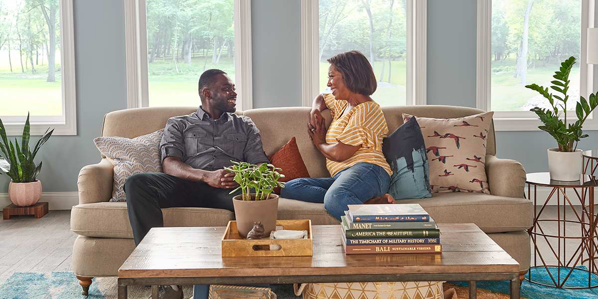 couple-sitting-on-a-couch-enjoying_excellent-indoor-air-quality-at-home