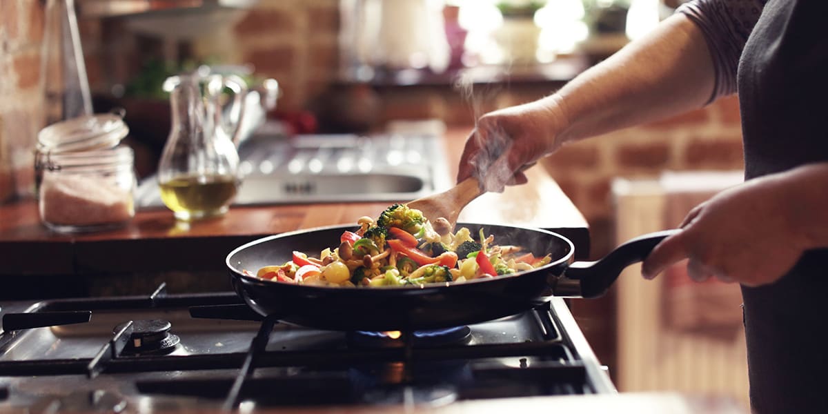 woman-cooking-on-gas-stove-which-is-a-source-of-carbon-monixide