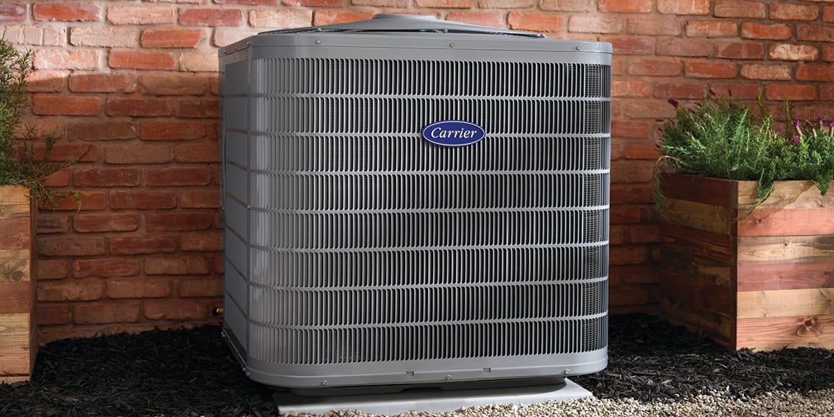 3-ton-heat-pump-sits-outside-of-a-brick-home