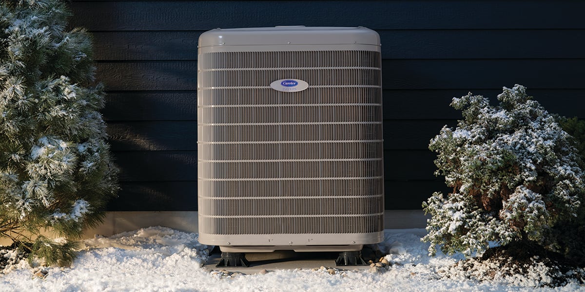 a-carrier-cold-climate-heat-pump-sits-outside-in-the-snow