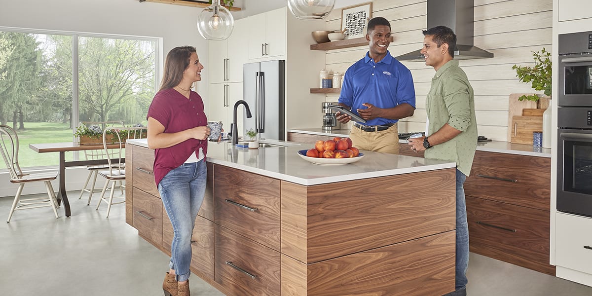 a-carrier-dealer-discusses-hvac-systems-and-types-of-hvac-equipment-with-a-couple