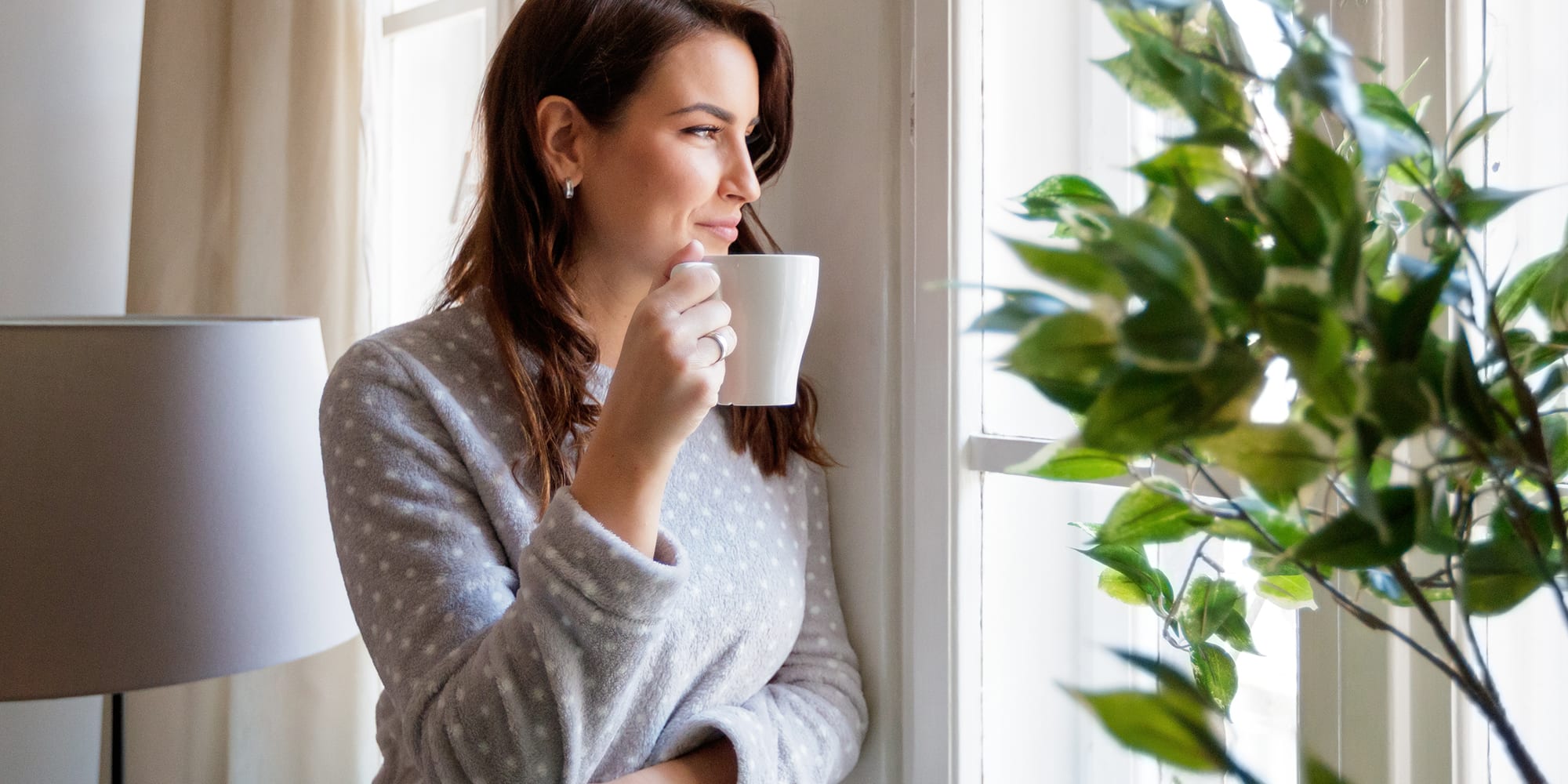 woman-drinking-coffee-by-window
