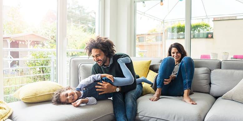 family-laughing-on-couch