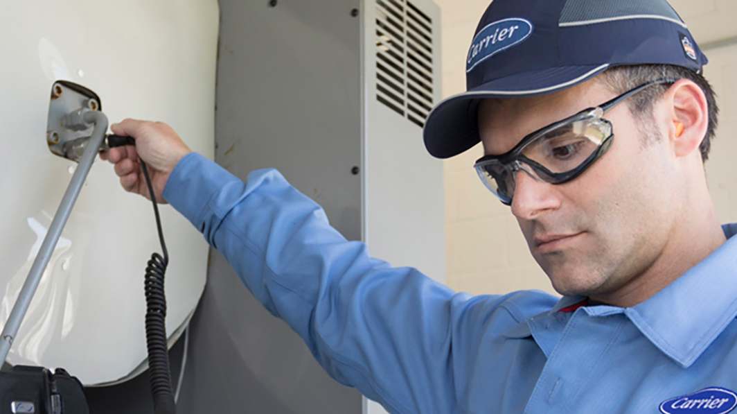 carrier-technician-evaluating-hvac-equipment-sm