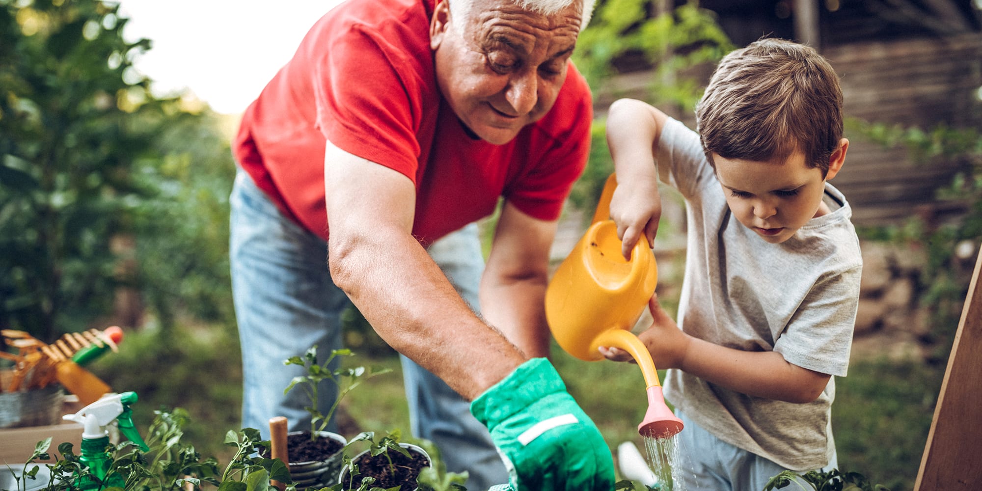 grandfather-and-boy-gardening a grandfather talks to a boy about what is geothermal heating while gardening