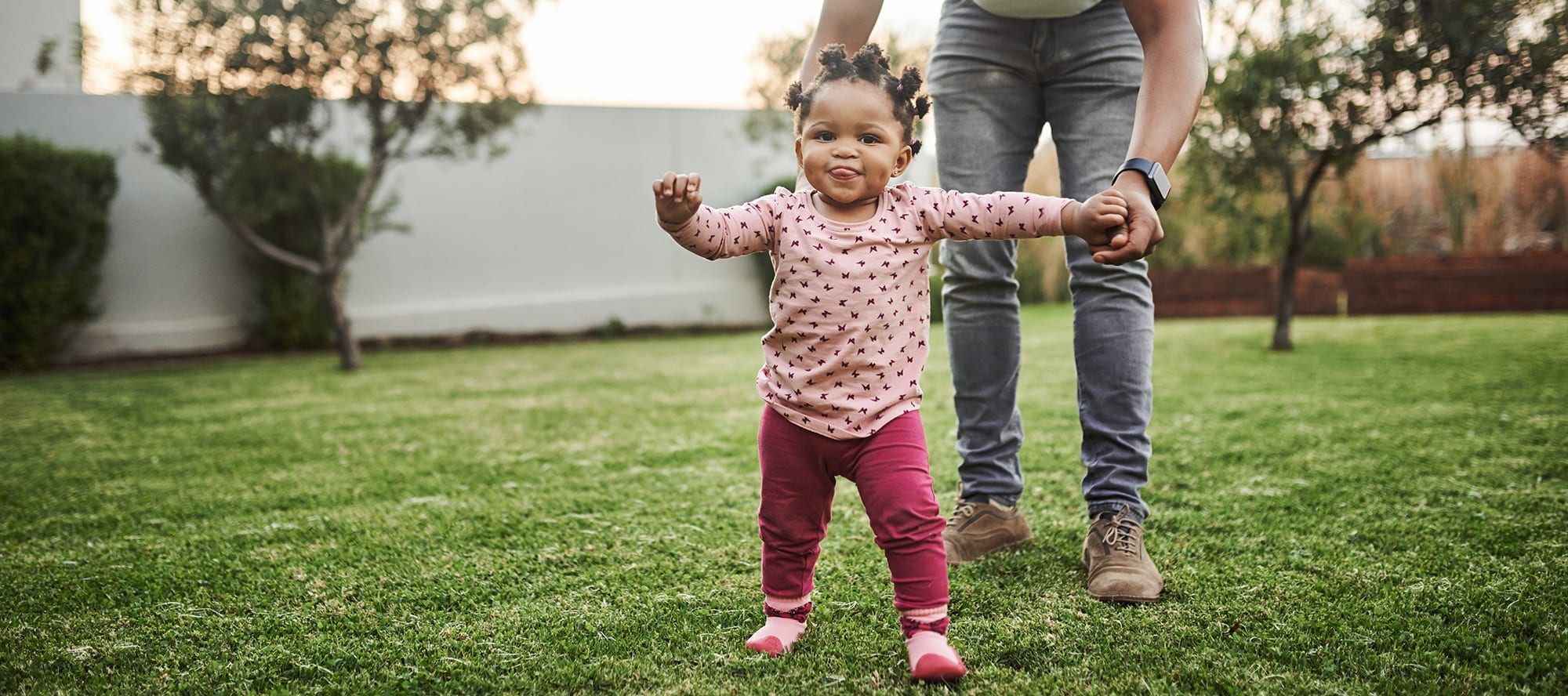 geothermal-energy-cost a girl in the backyard of a home benefiting from low geothermal heat pump cost