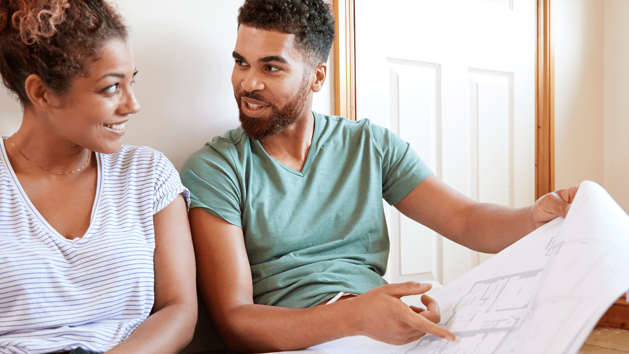 man-and-woman-remodeling-plans a man and woman discuss replacing fan coil units
