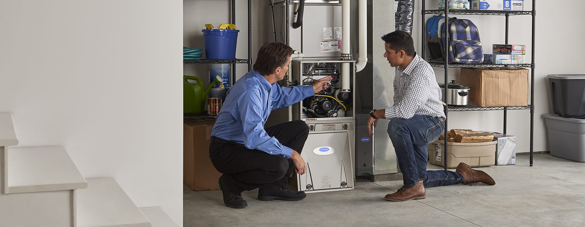 Technician discussing what is a furnace vs boiler with homeowner who owns boiler heating system Technician discussing what is a furnace vs boiler with homeowner who owns boiler heating system