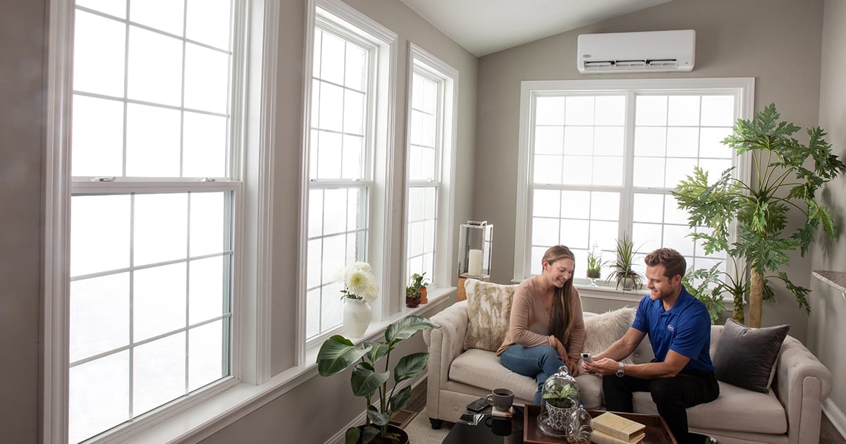 a dealer explaining to a homeowner how to size a mini split system