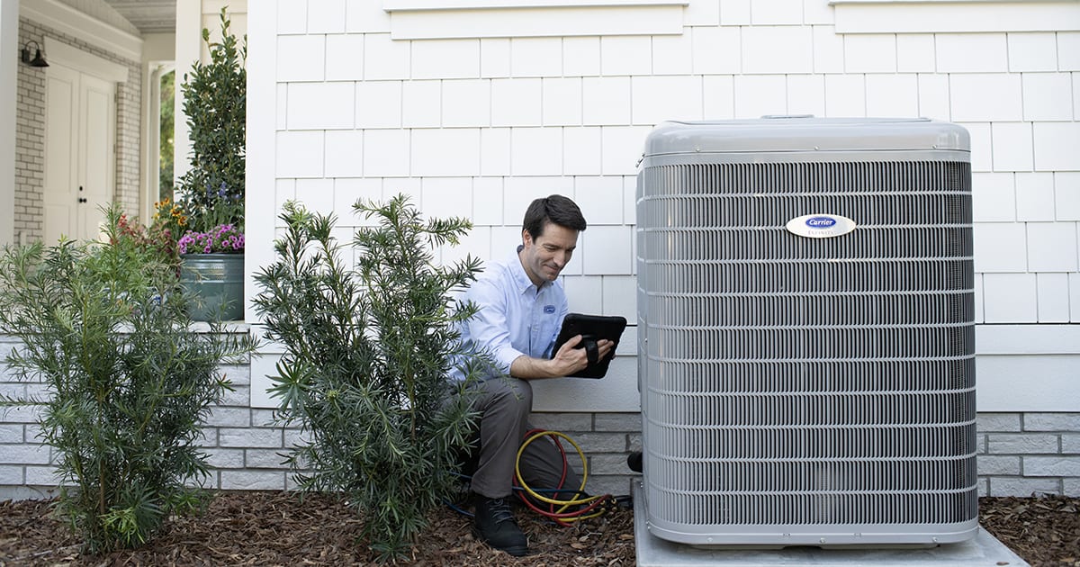 hvac-dealer-installing-air-conditioner-after-homeowner-agrees-to-AC-unit-cost An HVAC dealer installing air conditioner after homeowner agrees to AC unit cost.