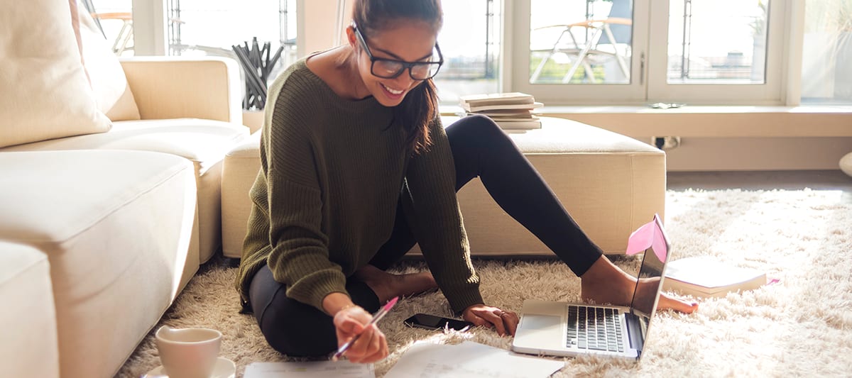 a woman researches with a laptop and paper does uv light kill mold and bacteria
