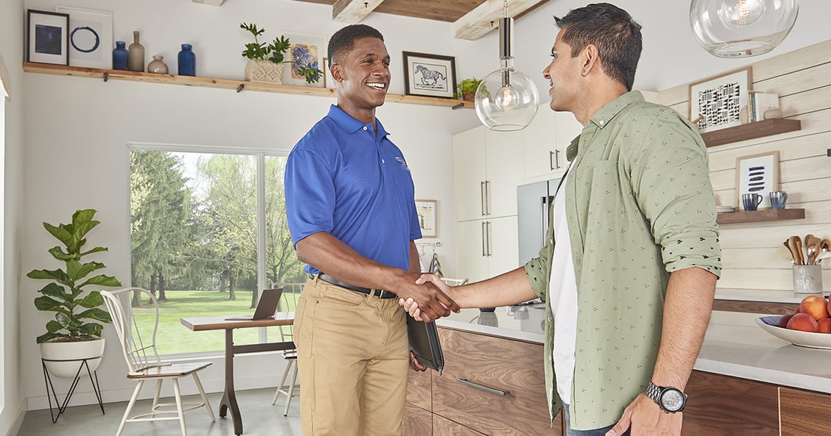 a carrier dealer shakes a homeowner’s hand after boiler installation a carrier dealer shakes a homeowner’s hand after boiler installation