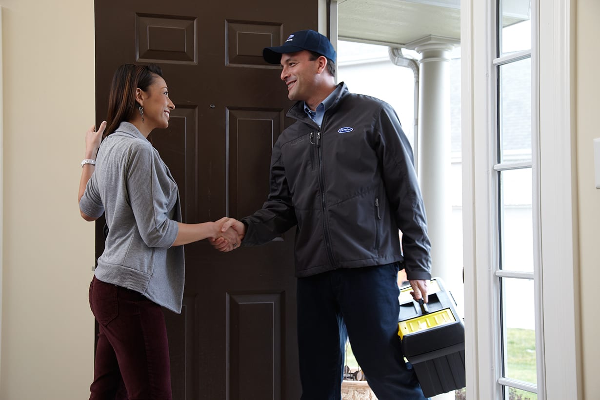 A furnace repair service expert shaking hands with a homeowner after heating repair A furnace repair service expert shaking hands with a homeowner after heating repair.