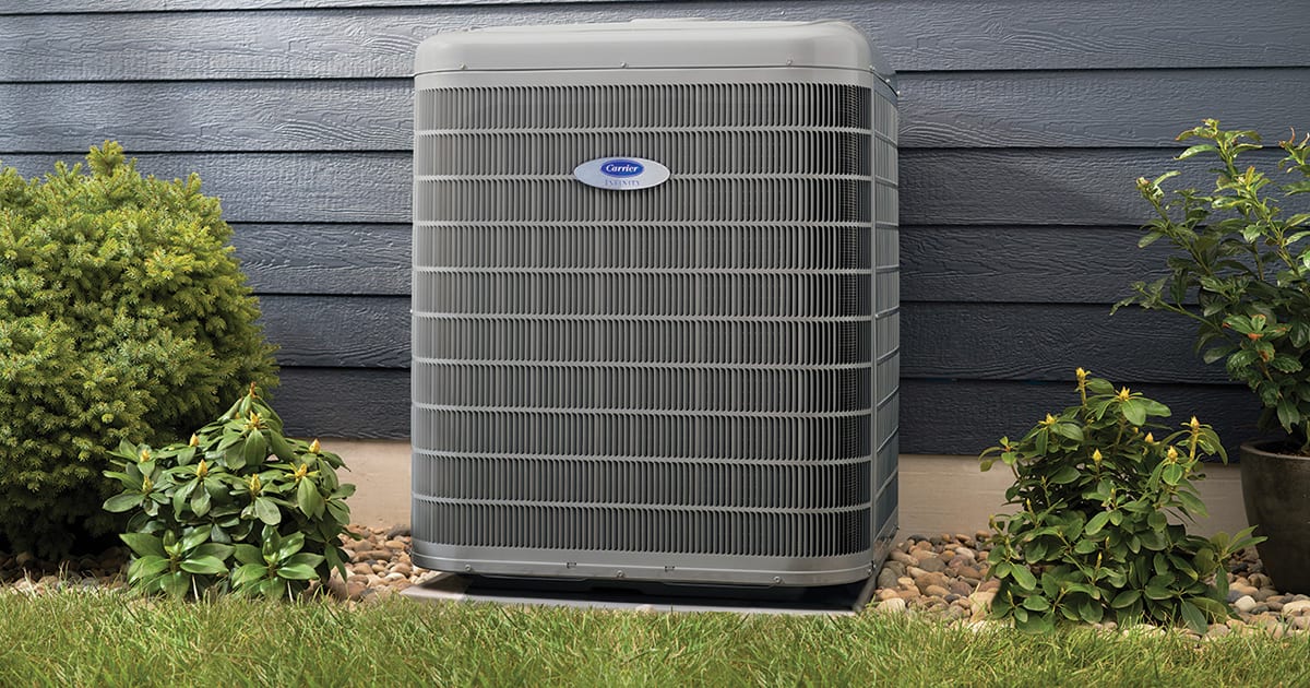 a carrier heat pump with high heat pump efficiency sits outside a home a carrier heat pump with high heat pump efficiency sits outside a home