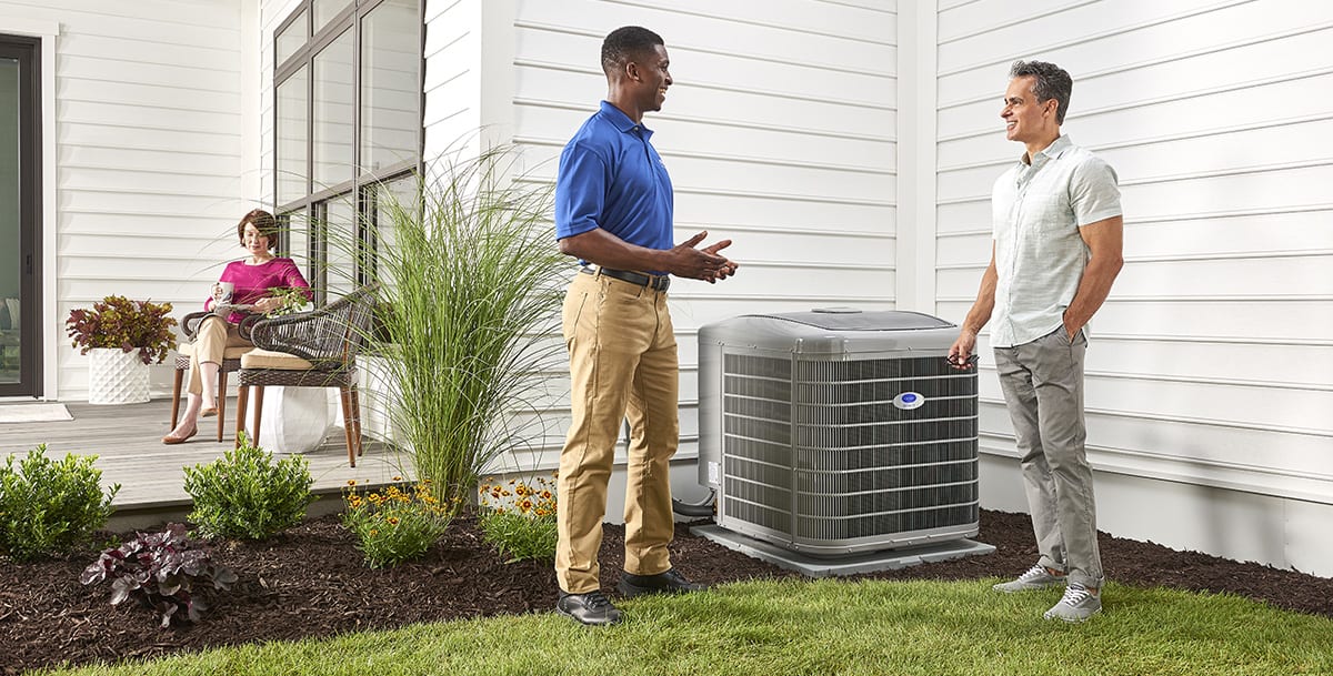 a carrier dealer discusses dual fuel heat pump options with a homeowner a carrier dealer discusses dual fuel heat pump options with a homeowner