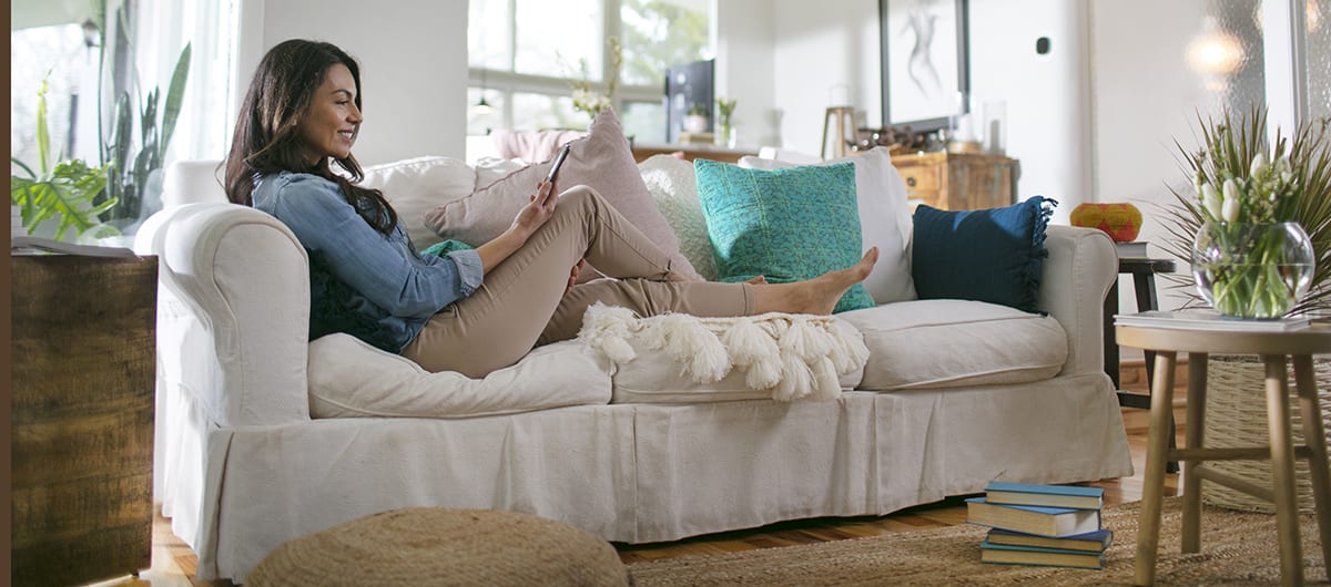 a woman researches dehumidifier for basement options on her phone a woman researches dehumidifier for basement options on her phone