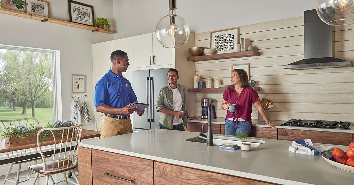 a carrier dealer discusses wall ac unit benefits with homeowners a carrier dealer discusses wall ac unit benefits with homeowners