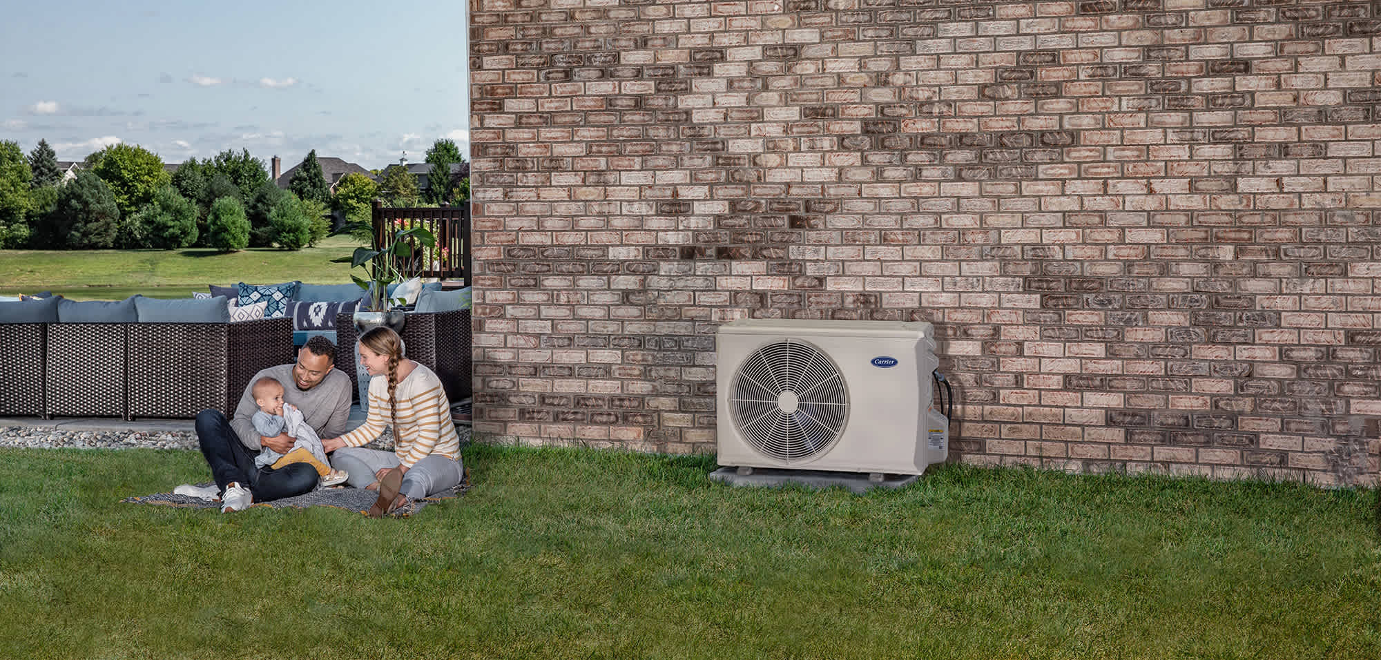 a family sits outside near their mini split heat pump a family sits outside near their mini split heat pump