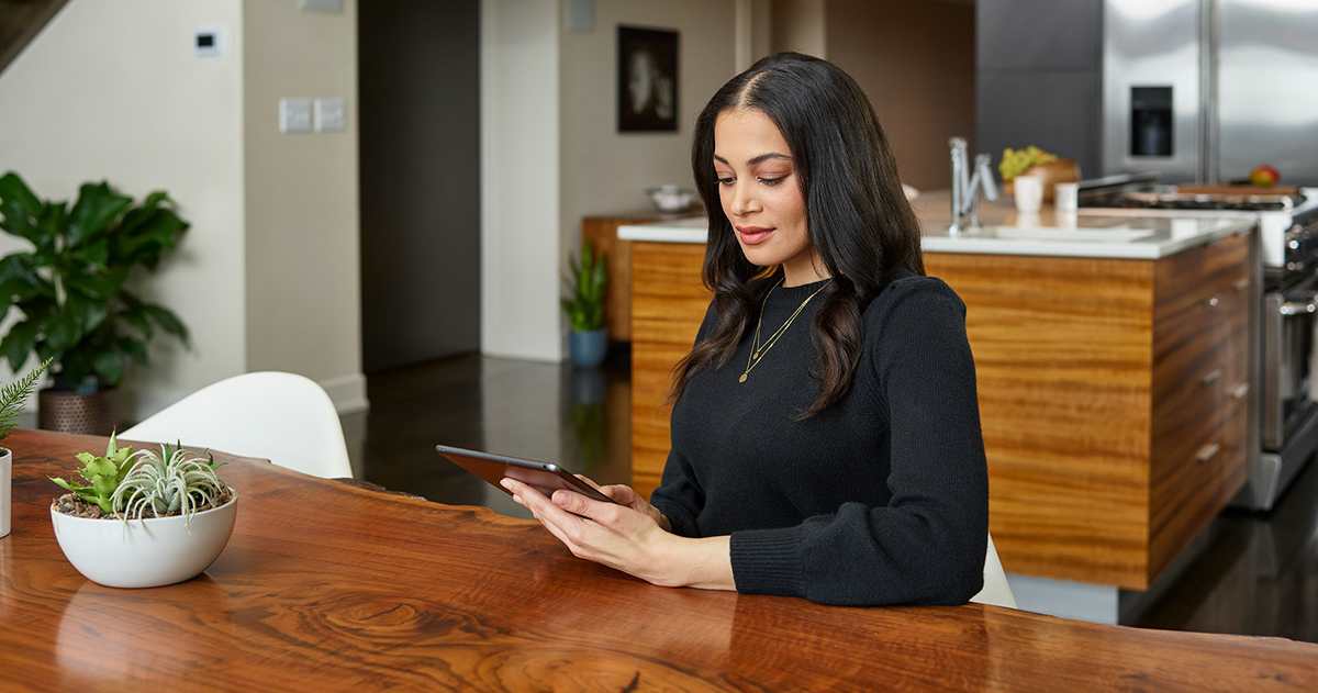 a woman searches for hvac replacement near me on tablet a woman searches for hvac replacement near me on tablet