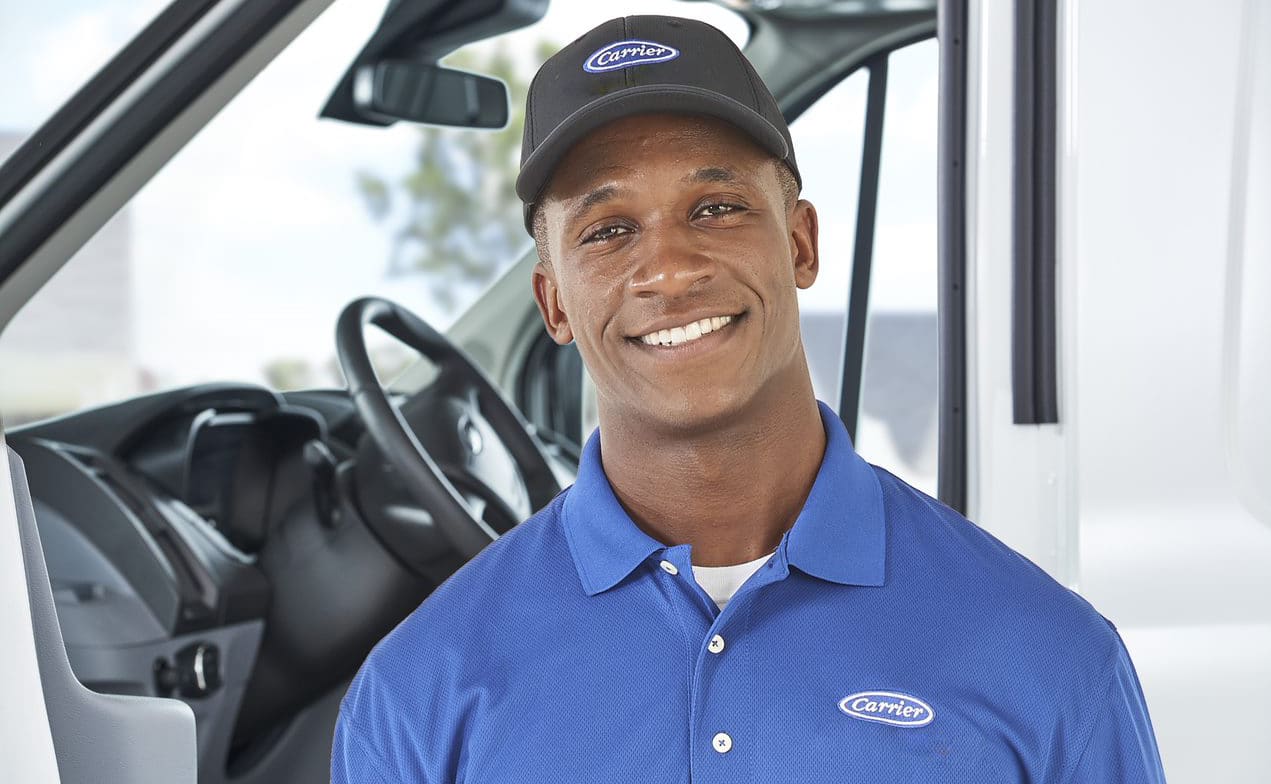 a carrier dealer smiles after performing oil furnace cleaning a carrier dealer smiles after performing oil furnace cleaning