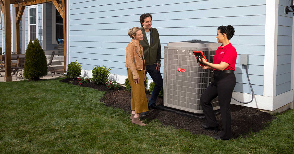 a bryant dealer discusses home ac recharge with couple