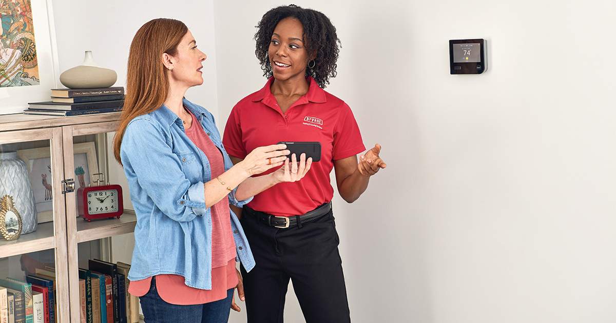 a bryant dealer explains hvac equipment types to a woman a bryant dealer explains hvac equipment types to a woman