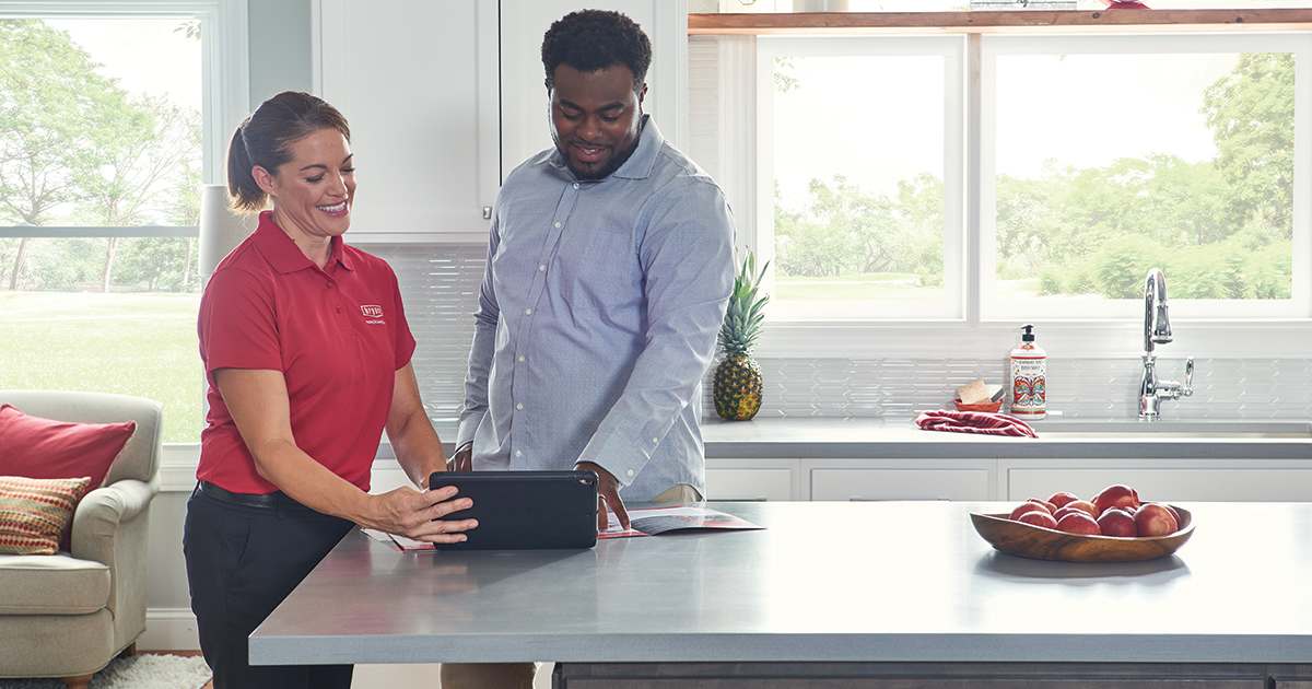 a bryant dealer shows a homeowner humidifier vs dehumidifier options