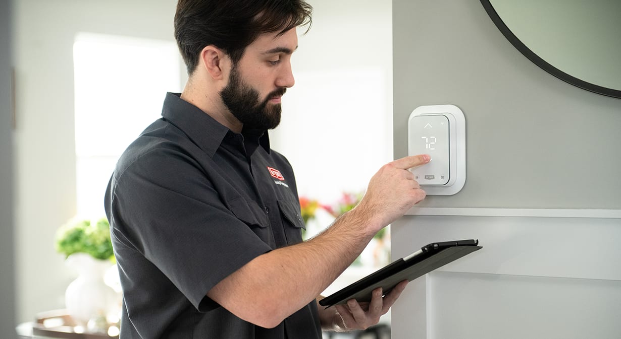 a bryant dealer sets an energy saving thermostat a bryant dealer sets an energy saving thermostat