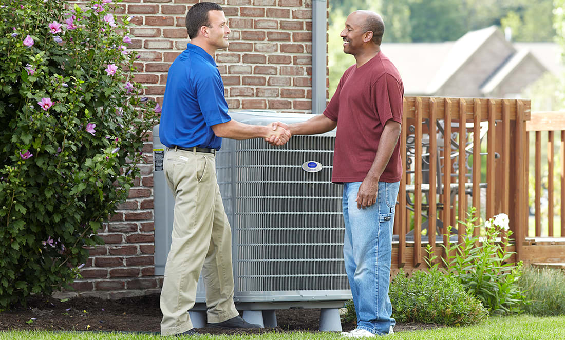 a carrier dealer and homeowner shake hands next to 5 ton ac unit a carrier dealer and homeowner shake hands next to 5 ton ac unit