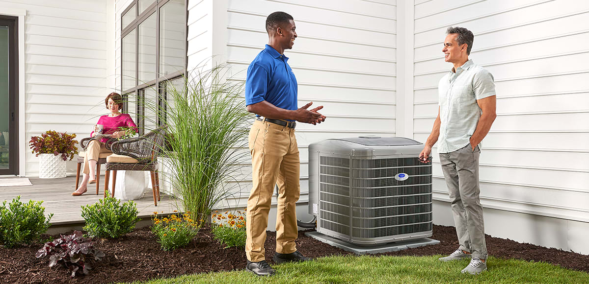 a carrier dealer and homeowner talk next to 3 ton ac unit a carrier dealer and homeowner talk next to 3 ton ac unit
