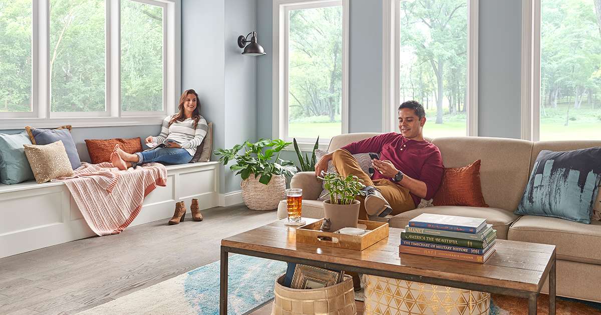 homeowners relax in living room with air to water heat pump installed homeowners relax in living room with air to water heat pump installed