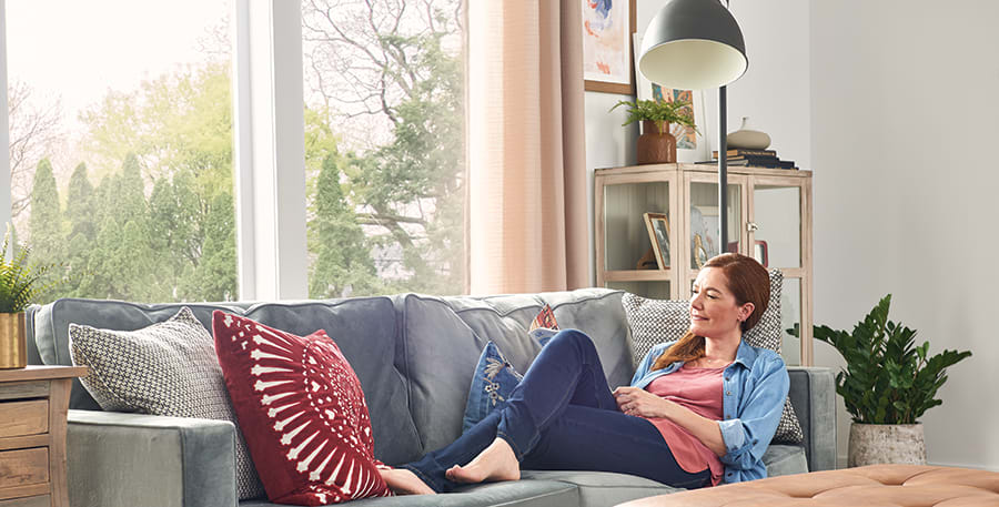 a homeowner relaxes in home with bryant whole home dehumidifier installed