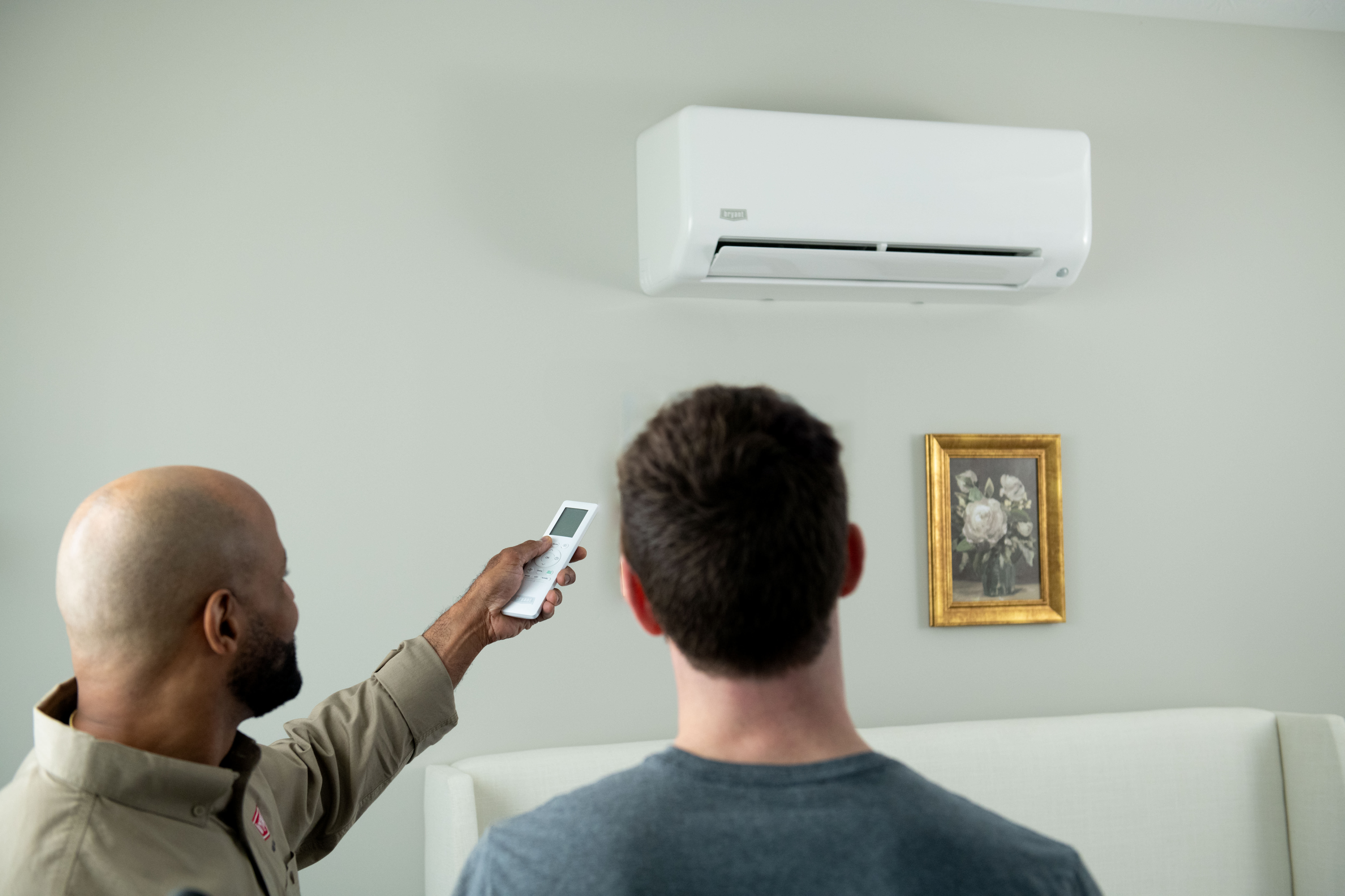 a bryant dealer explains mini split heating and cooling to homeowner