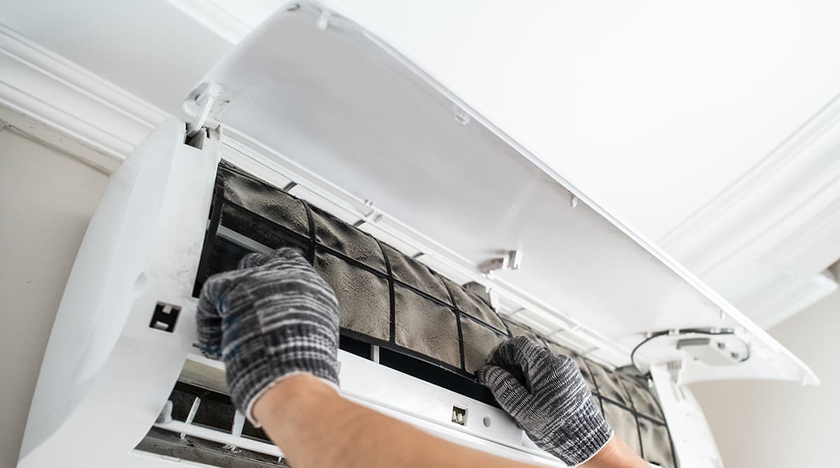 a homeowner changes out mini split air filter