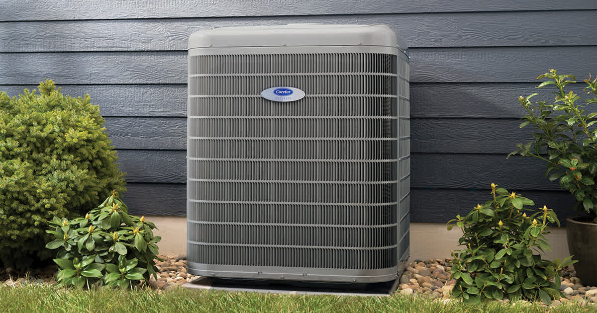 carrier-variable-speed-air-conditioner-installed-outside-blue-home