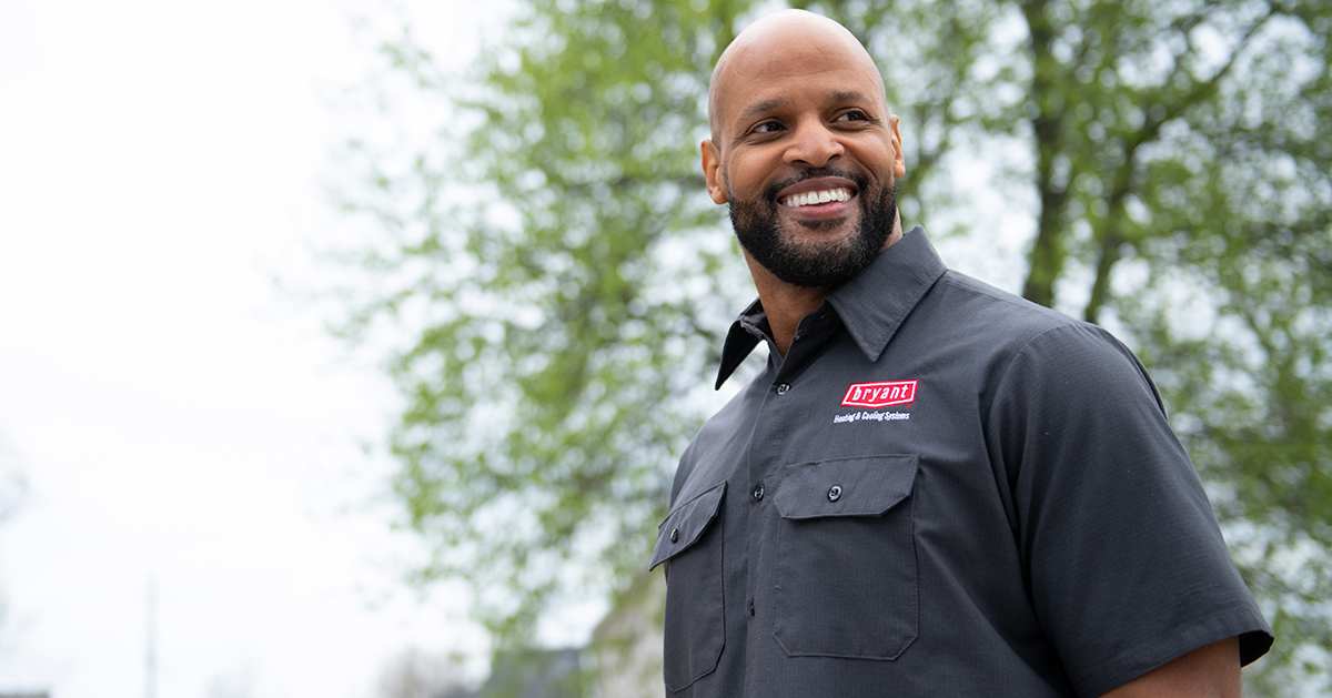 a bryant dealer smiles after servicing r22 refrigerant hvac system
