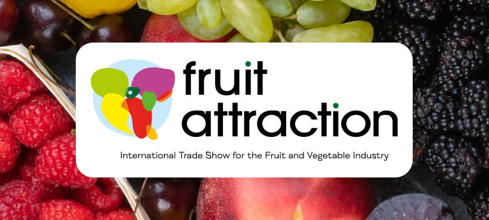 Fruit Attraction logo over background of fruits and vegetables