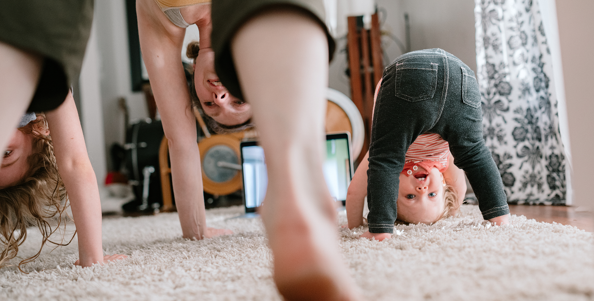 mom-and-kids-do-head-stands-on-carpet