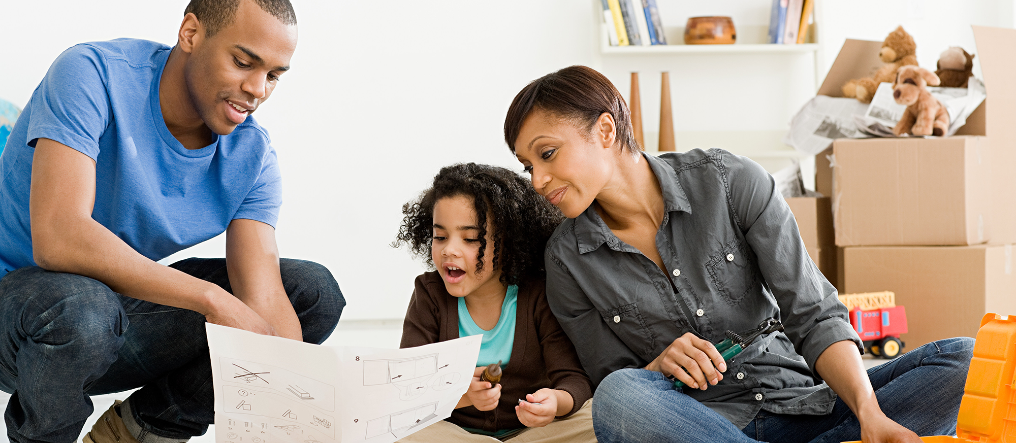 three-person-family-looking-at-house-information three-person-family-looking-at-house-information