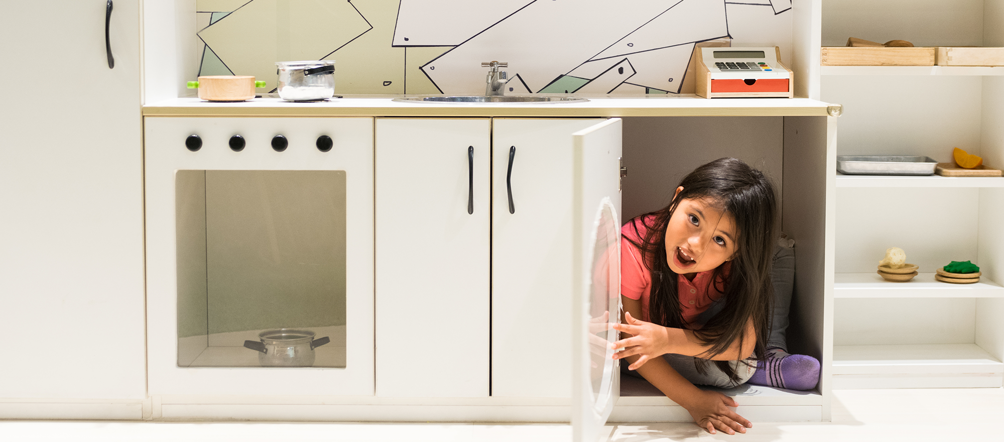 little-girl-in-play-kitchen little-girl-in-play-kitchen