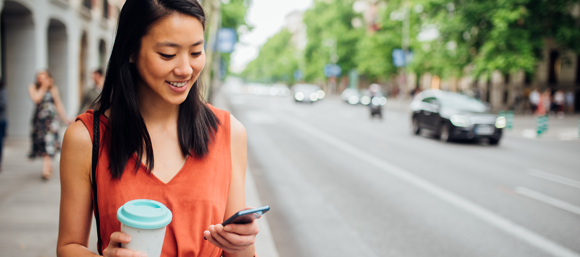 woman-mobile-phone-street-smart-thermostat woman-mobile-phone-street-smart-thermostat