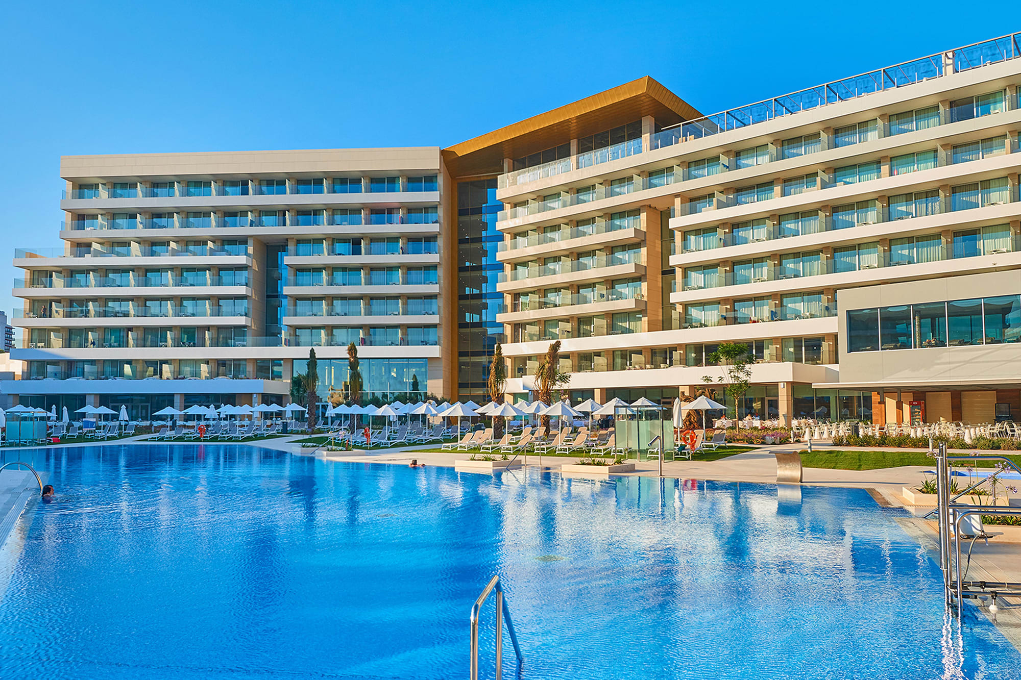 A photo of a hotel building by the pool A photo of a hotel building by the pool