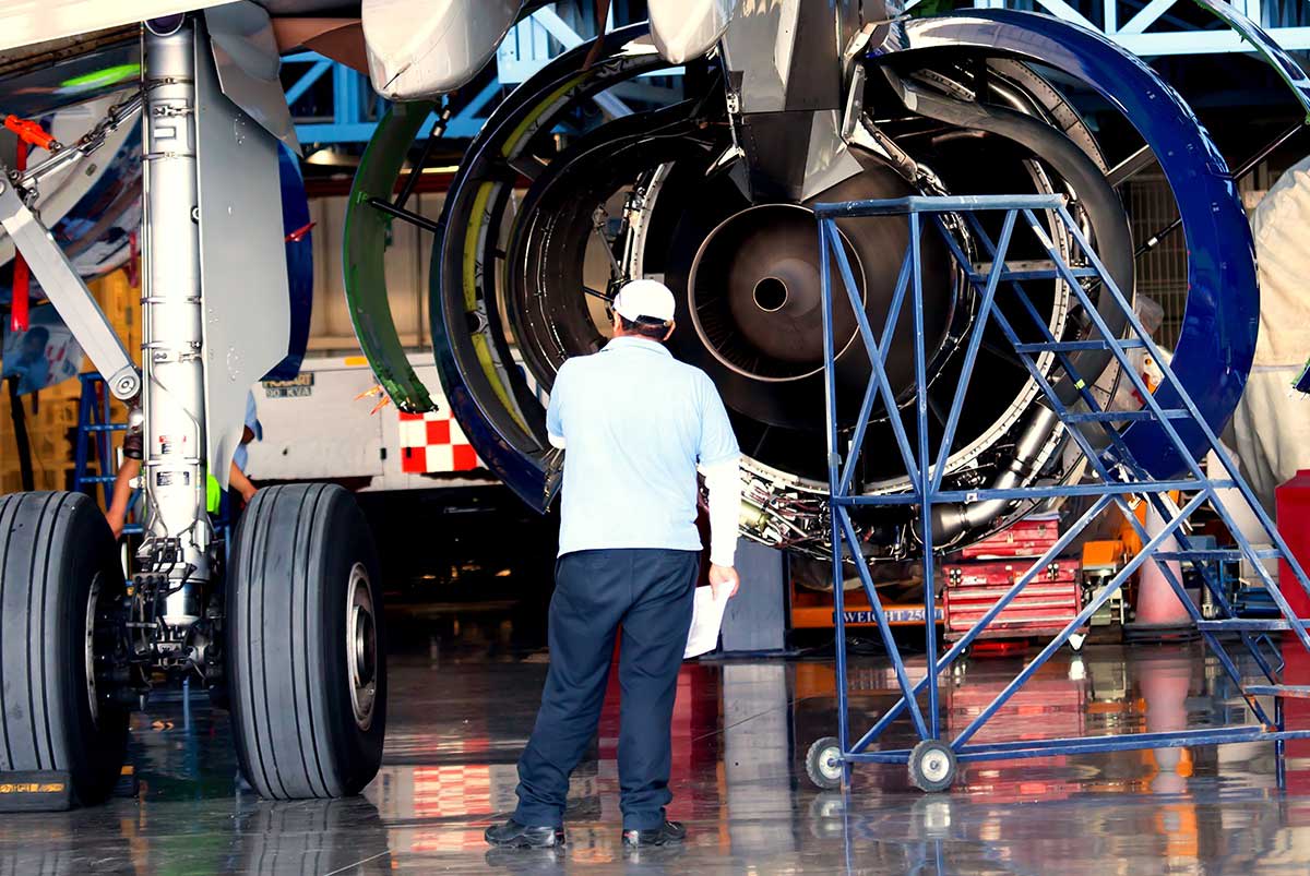 mechanic-inspecting-airplane-engine